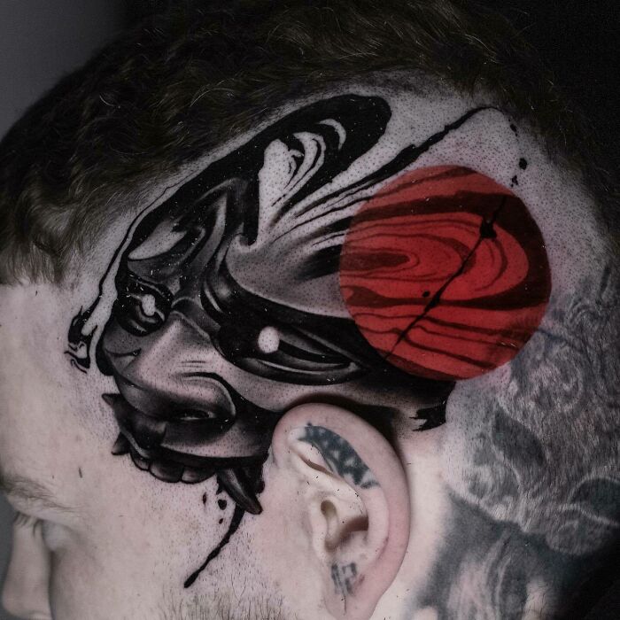 Trash Polka tattoo design featuring abstract black shapes and a red circle on a person's shaved head.