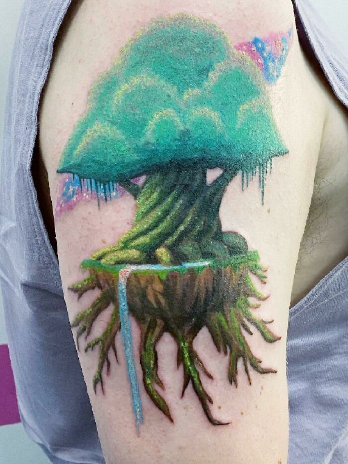 Tattoo of a floating, majestic tree with roots and waterfall, celebrating the wonders of nature.