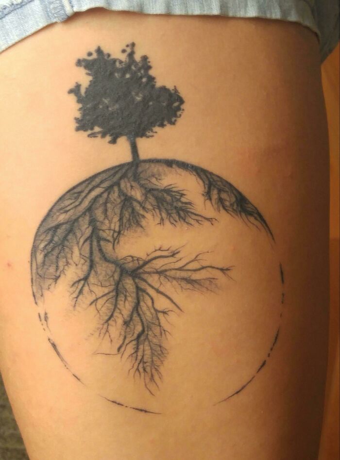 Tree tattoo with intricate roots and canopy, symbolizing nature's wonders.