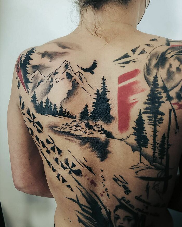 Person with a full-back Trash Polka tattoo featuring mountains, trees, and abstract red and black elements.
