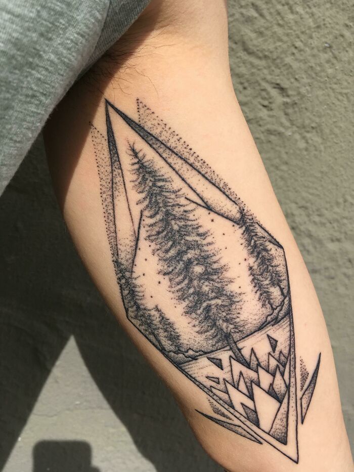 Geometric tree tattoo on forearm, showcasing nature's beauty and artistic detail.