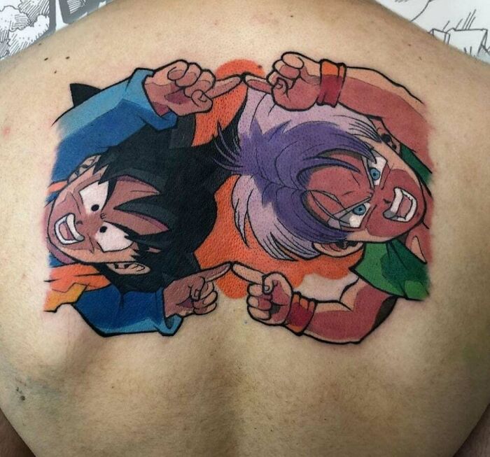 Anime tattoos featuring dynamic characters on a person's upper back, showcasing vibrant colors and detail.