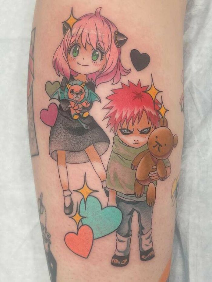 Colorful anime tattoo featuring two cute chibi characters with hearts, showcasing cool designs.