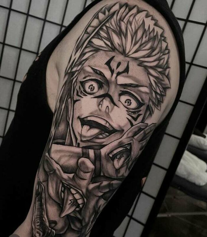Anime tattoo sleeve featuring a detailed manga character design on an upper arm, showcasing expert artistry.
