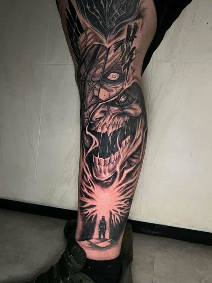 Anime tattoo featuring a dramatic scene with a roaring creature and a silhouetted figure, showcasing intense artistry.
