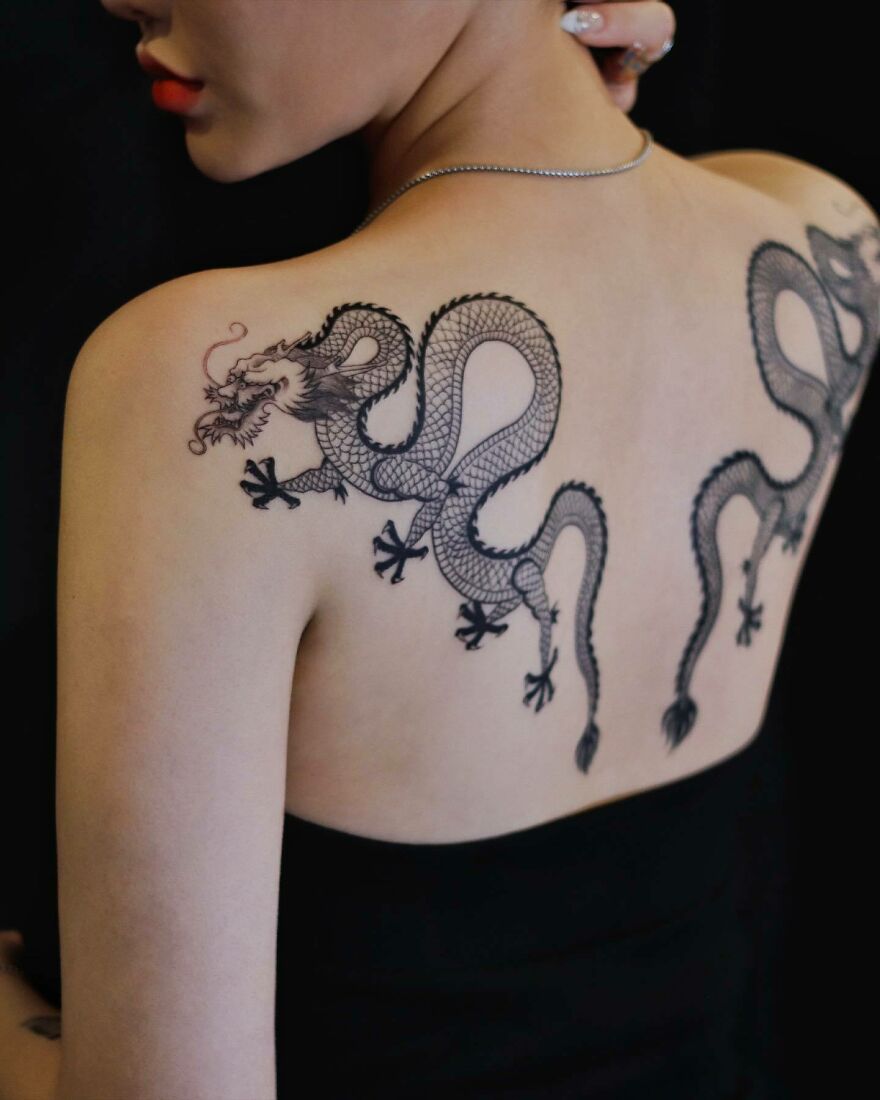 Intricate dragon tattoo design on a person's back, showcasing detailed scales and elegant curves.