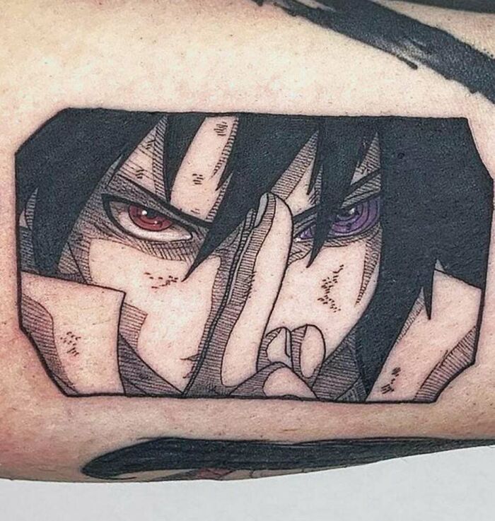Anime tattoo featuring a character with intense eyes and hand gesture, showcasing detailed artistry.