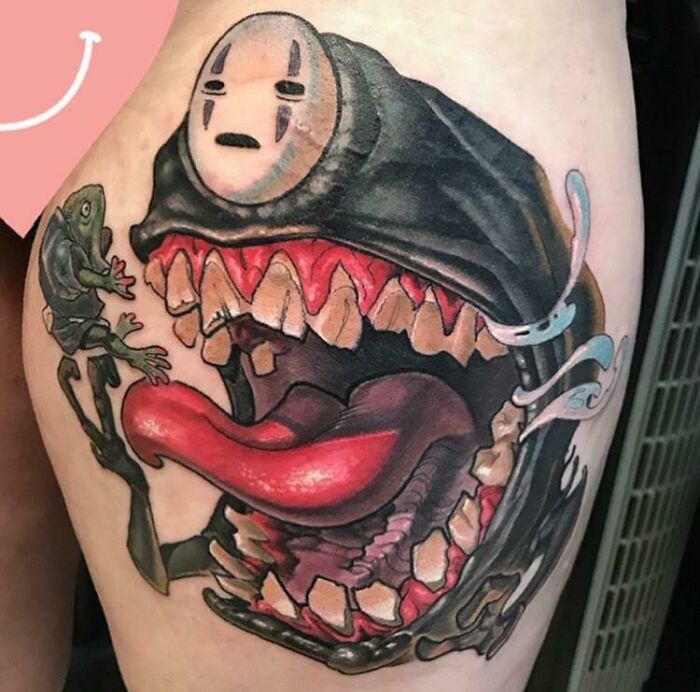 Anime tattoo featuring a dynamic design, blending elements of a wide-open mouth and a small creature.