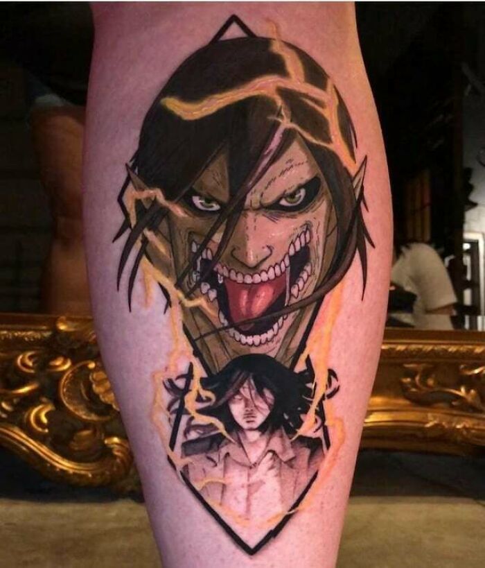 Anime tattoo featuring a fierce character design on a leg, showcasing dynamic expressions and vibrant colors.