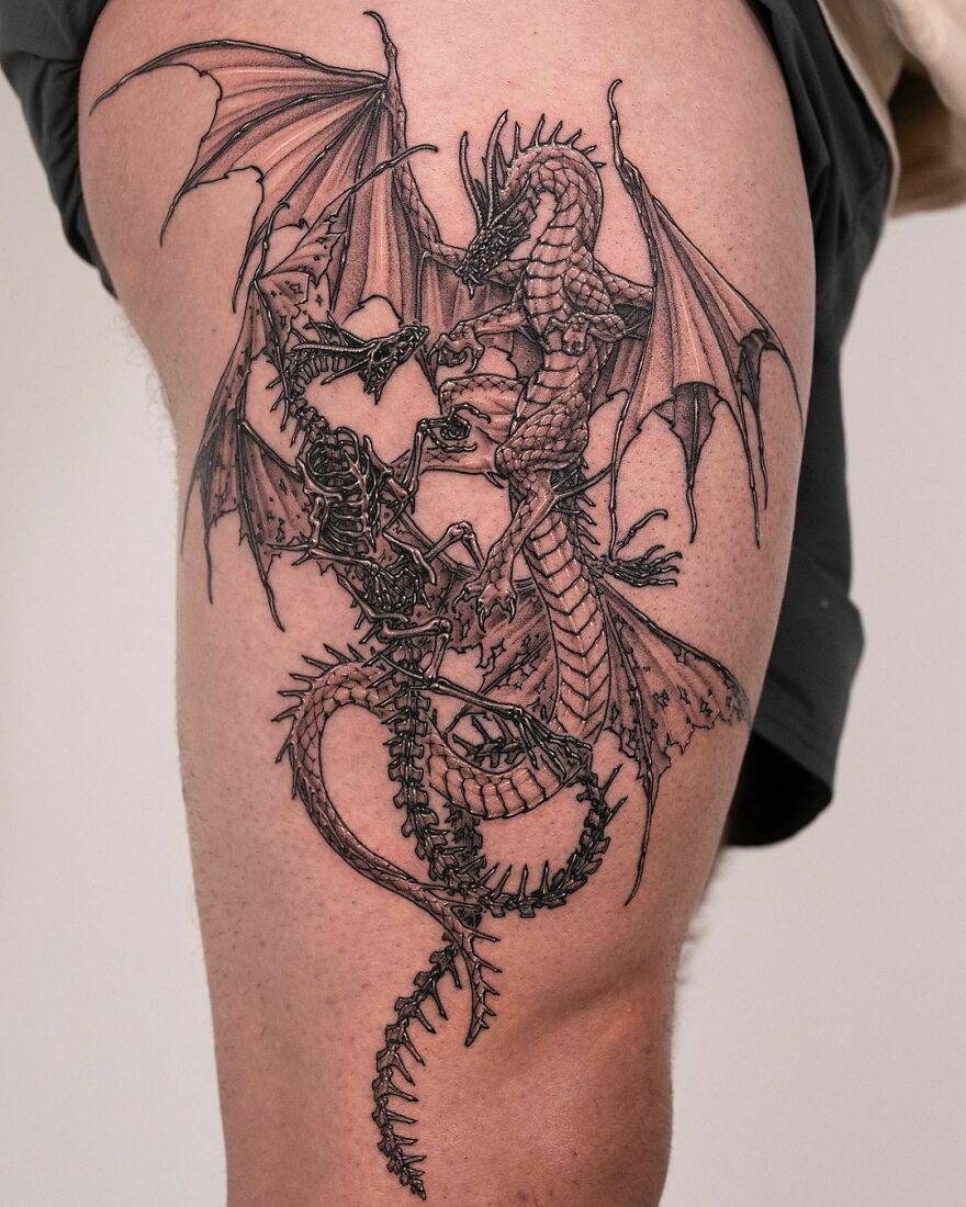 Intricate dragon tattoo design on a person's thigh, showcasing detailed wings and scales.