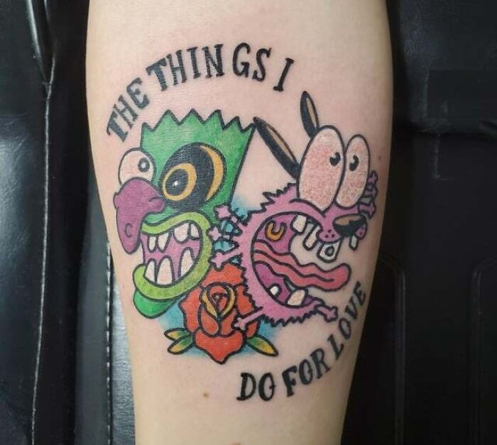 '90s tattoo featuring cartoon characters and text, with vibrant colors and a rose design.