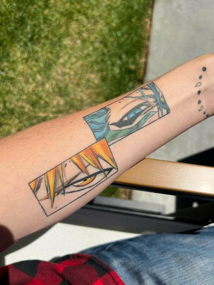 Anime tattoo featuring detailed eye designs on an arm, showcasing vibrant colors and intricate line work.