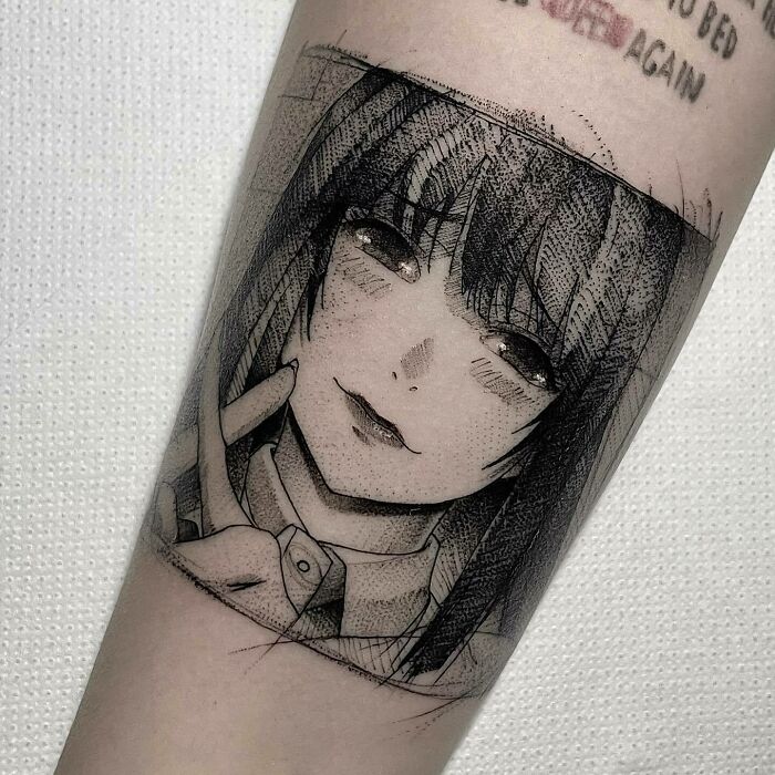 Anime tattoo of a character with long hair and a subtle smile, showcasing intricate shading and line work.