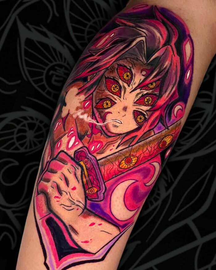 Anime tattoo of a fierce character with multiple eyes and vibrant pink and purple hues, enhancing the dynamic design.
