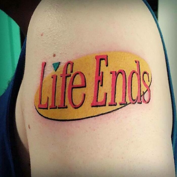 '90s tattoo with a twist on a famous sitcom logo, reading "Life Ends" in red letters on a yellow background.