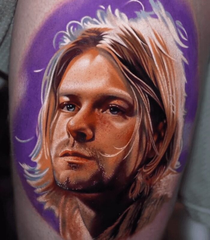 A ‘90s tattoo design featuring a portrait with long hair and a purple background, reflecting the decade's culture.