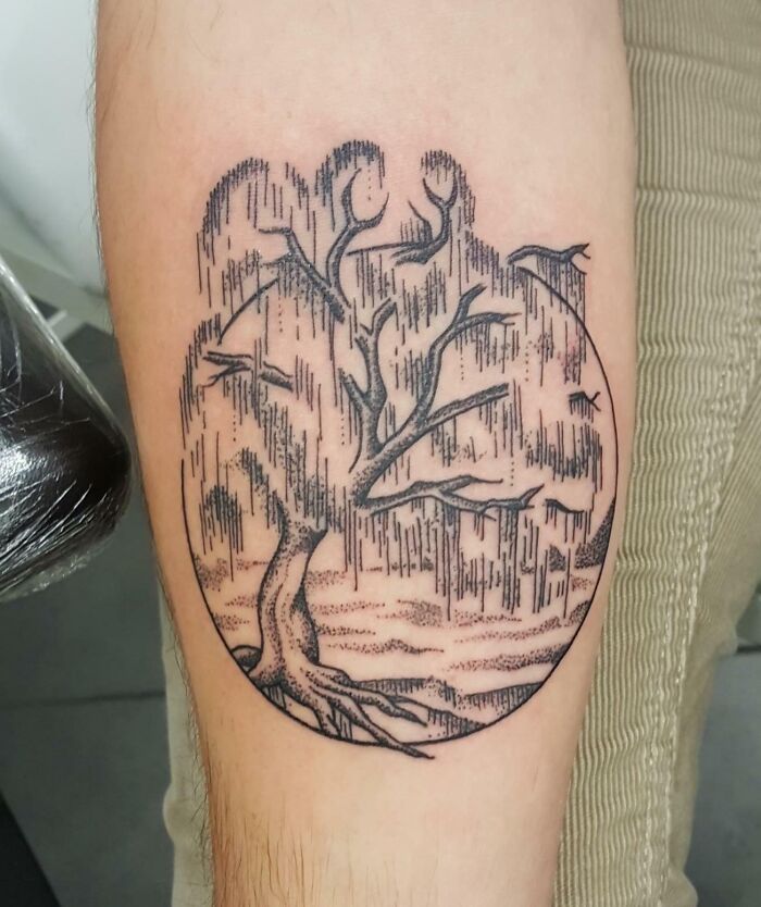 Tree tattoo with branches and circular design, showcasing the wonders of nature.