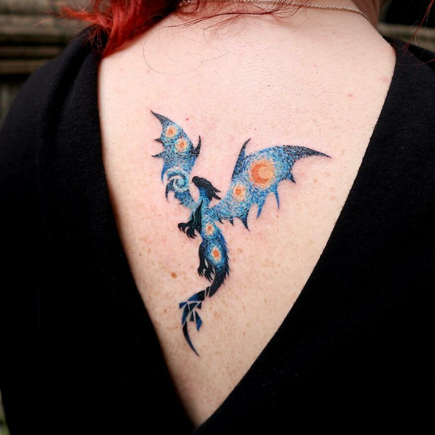 Colorful dragon tattoo resembling Van Gogh's Starry Night on a person's upper back.