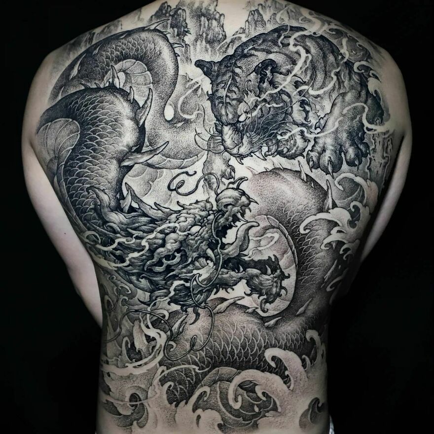Intricate dragon tattoo on a person's back, featuring detailed scales and a dynamic design.