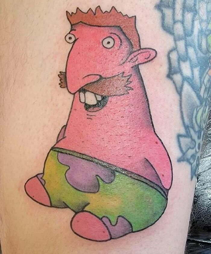 Cartoon character tattoo from the ‘90s with vibrant colors and playful design on skin.