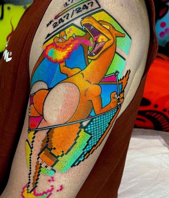 Anime tattoo of a fire-breathing creature with colorful geometric background on arm.