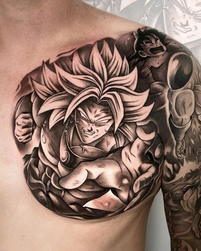 Anime tattoo featuring a powerful character with spiky hair and detailed shading on the upper chest.