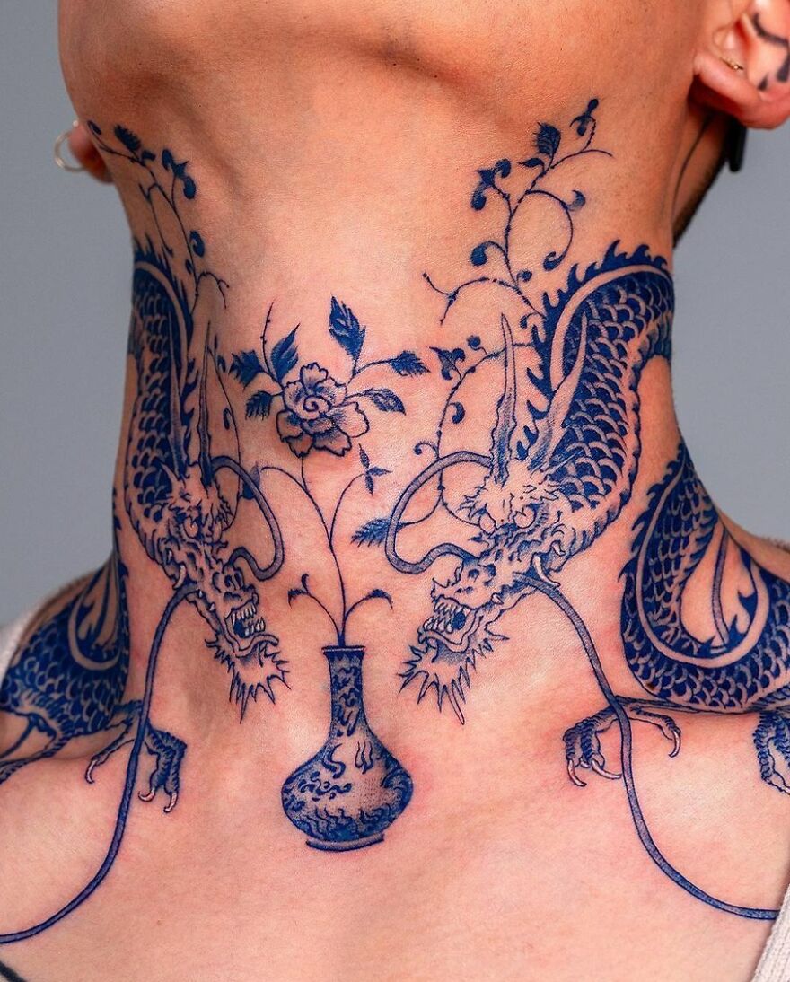 Neck tattoo featuring a detailed blue dragon design intertwined with floral elements.
