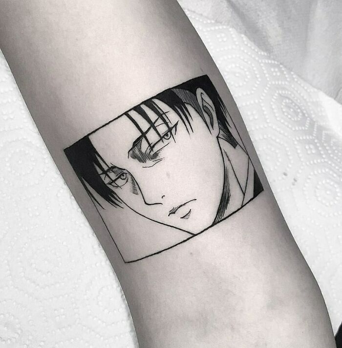 Anime tattoo featuring a detailed portrait on the arm, showcasing cool manga-inspired artistry.