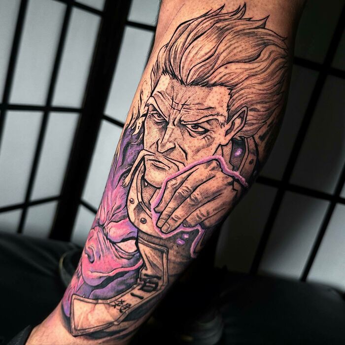 Anime tattoo featuring a detailed portrait with dynamic lines and vibrant colors on forearm.