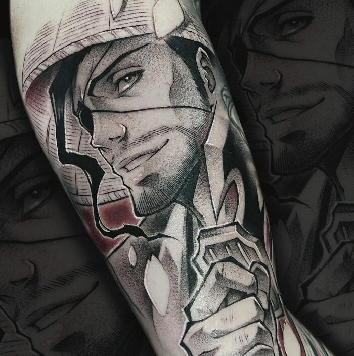 Anime tattoo featuring a detailed character with intense expression and intricate shading on the forearm.