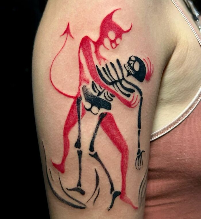 Trash Polka tattoo of a red devil and black skeleton on an arm.
