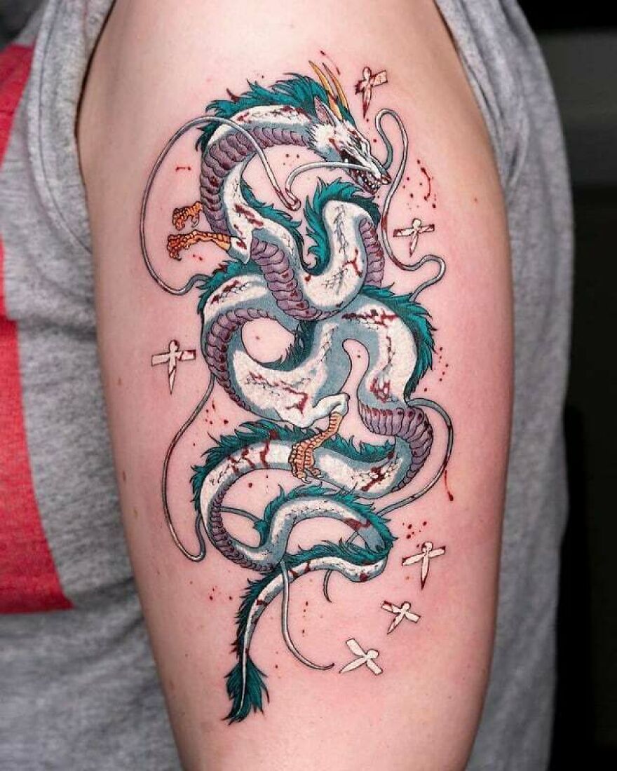 Detailed dragon tattoo on arm, showcasing vibrant colors and intricate design.