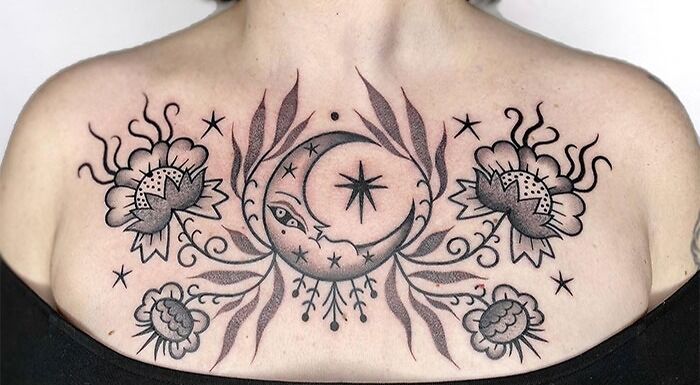 Collarbone tattoo featuring celestial and floral design with detailed stars and flowers on skin.