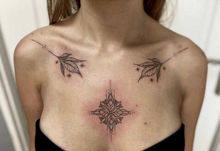 Delicate floral and geometric collarbone tattoos on woman.