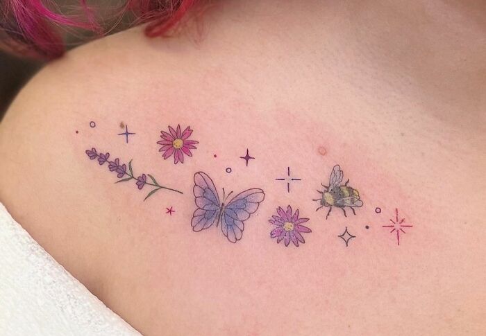 Colorful collarbone tattoo with a butterfly, flowers, and a bee, featuring delicate line art and soft shading.