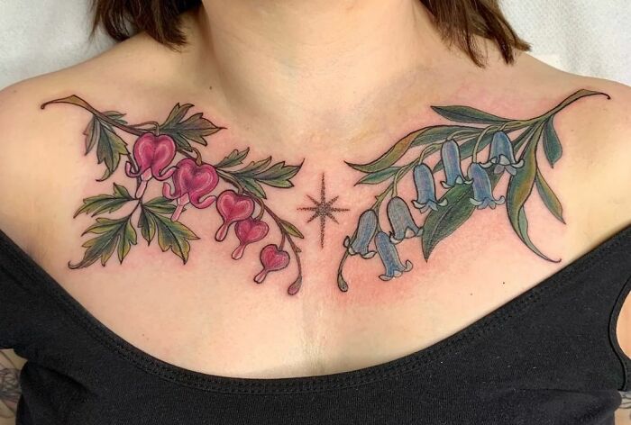 Collarbone tattoos featuring floral designs with pink and blue flowers on skin, emphasizing intricate detail.
