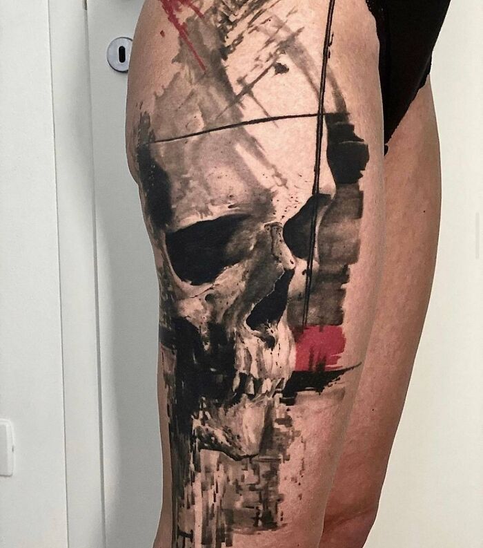 Trash Polka tattoo design featuring a skull with abstract red and black brushstrokes.