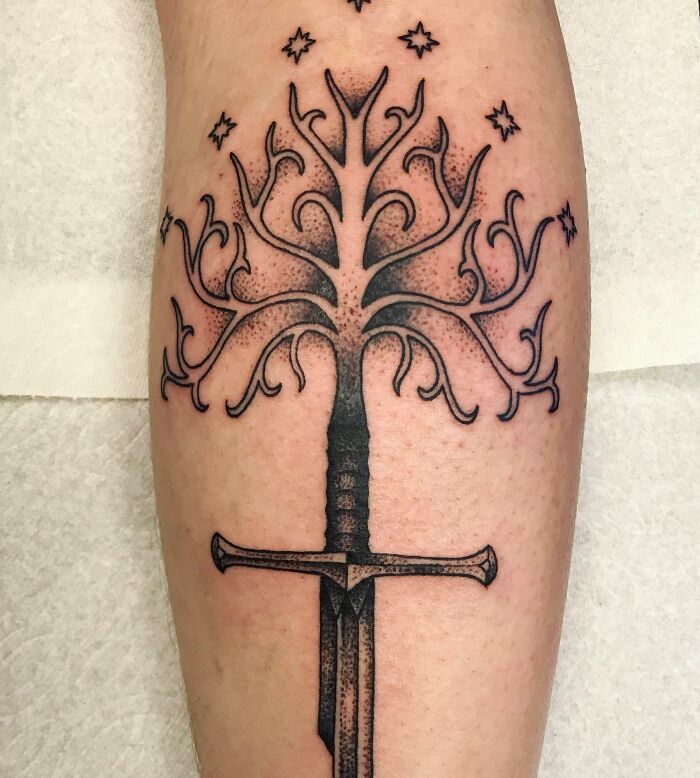 Majestic tree tattoo with interwoven branches and stars, symbolizing nature's wonder.
