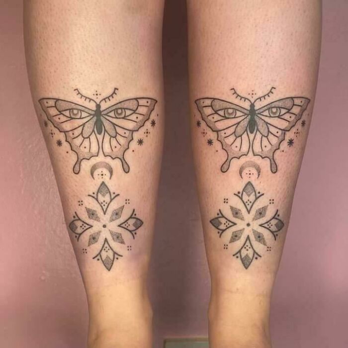 Two symmetrical butterfly tattoos on legs with geometric designs, featuring intricate linework and dot patterns.
