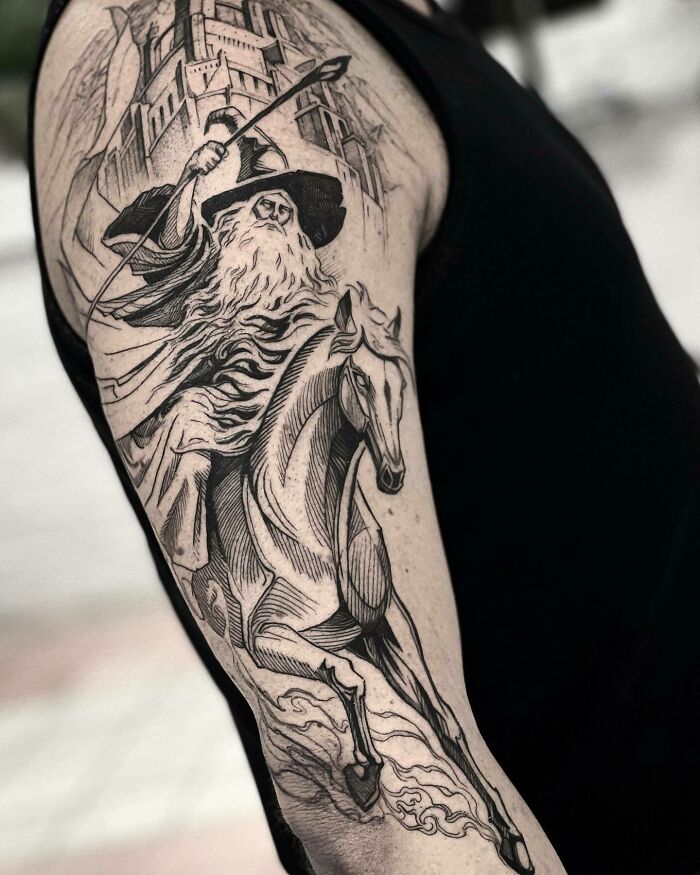 Lord of the Rings tattoo featuring a wizard on horseback, detailed in black ink, with a castle in the background.