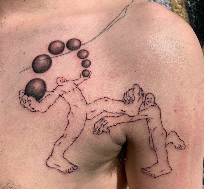 Unique collarbone tattoo design featuring abstract human figures and circular shapes.