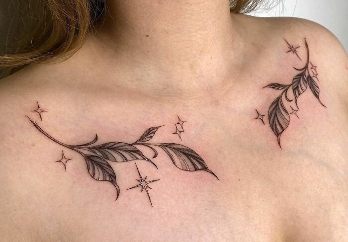Floral collarbone tattoo with intricate leaf details and stars, showcasing unique body art design for men and women.