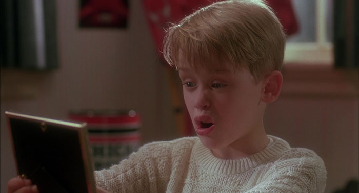 Kevin looking at the photo in a frame