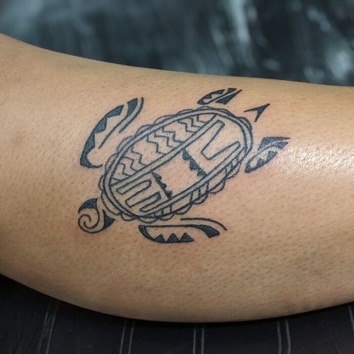 Tribal tattoo inspiration featuring a stylized turtle design on skin.