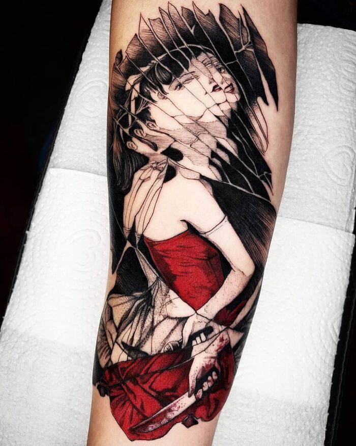Pop culture tattoo of a woman in a red dress with a fragmented, artistic design on an arm.