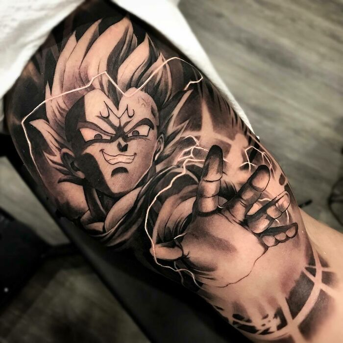 Pop culture tattoo of anime character with spiky hair and intense expression on arm, showcasing dynamic energy and detail.