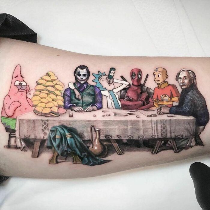 Pop culture tattoo of iconic characters gathered at a table, resembling a famous painting scene.