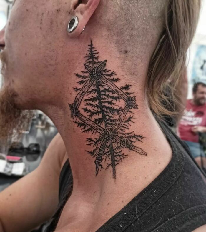 Neck tattoo featuring intricate tree design, showcasing the beauty of nature's wonders.