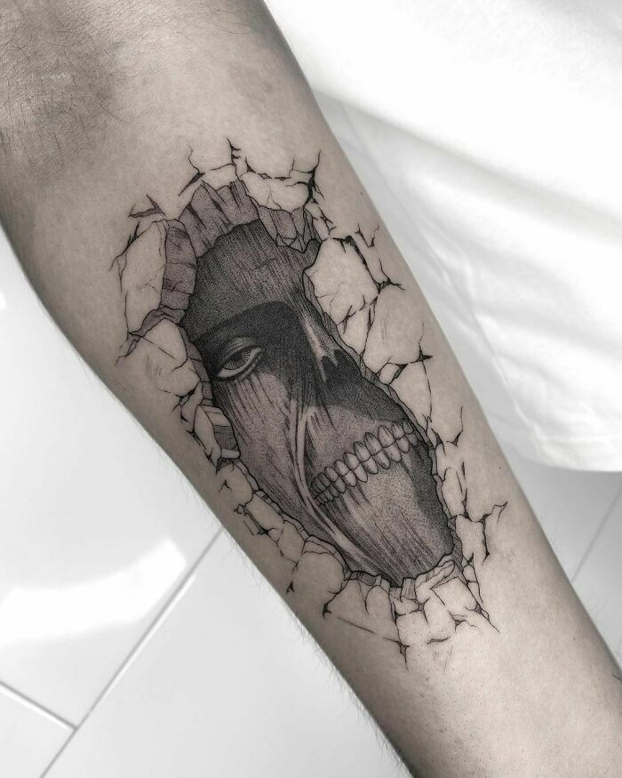 Pop culture tattoo of a skull breaking through c*****d skin on an arm.