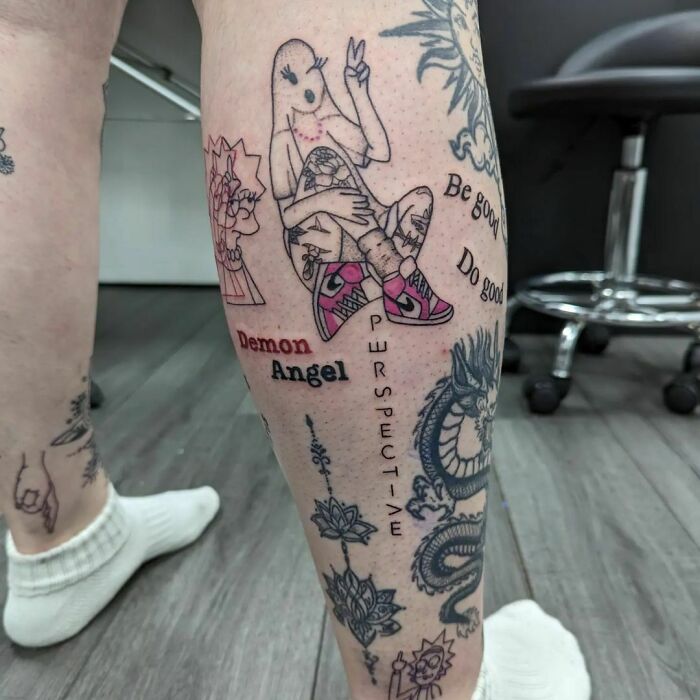 Leg displaying unique patchwork tattoos, featuring cartoon character, flowers, text, dragon motif, and geometric patterns.